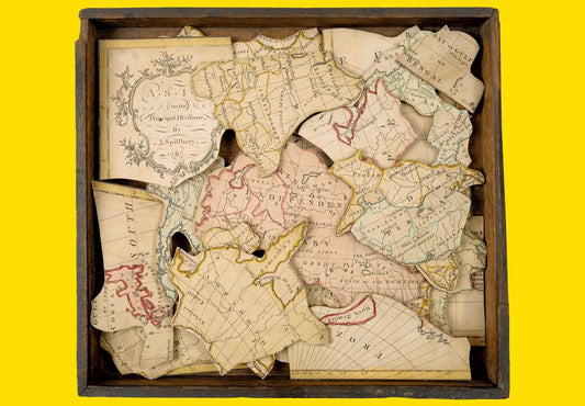 Old vintage jigsaw puzzle of a world map - the history of jigsaw puzzles