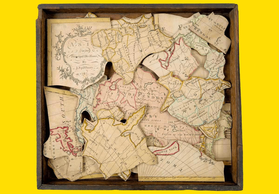 Old vintage jigsaw puzzle of a world map - the history of jigsaw puzzles