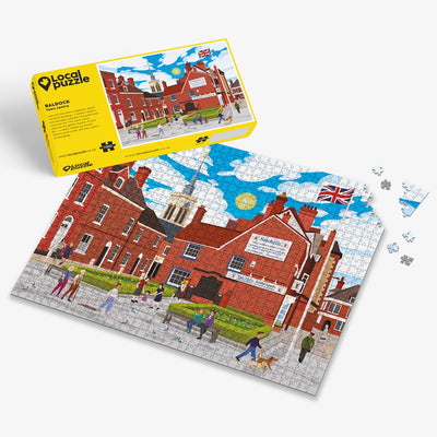 Baldock Town Centre Jigsaw puzzle with a colourful scene of a town centre and yellow box packaging on a white background