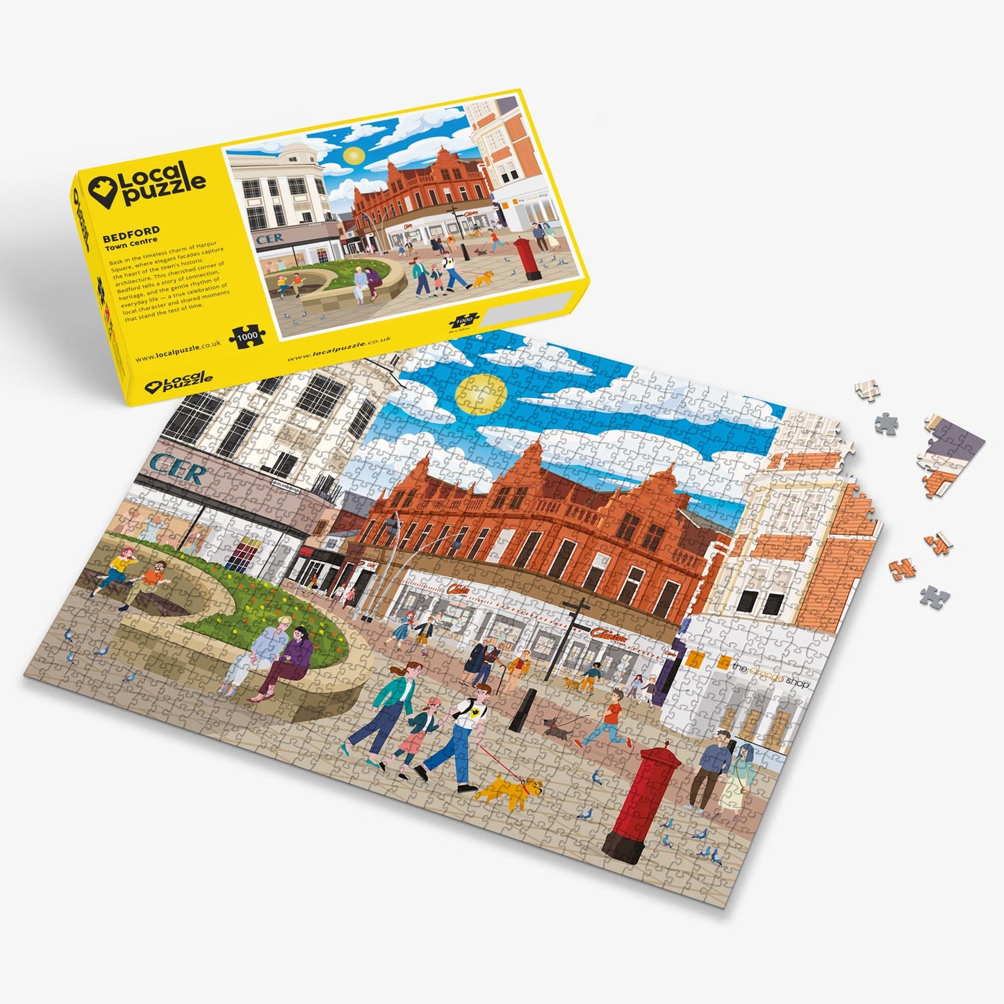 Bedford town centre Jigsaw puzzle with a colourful scene of a town square and yellow box packaging on a white background