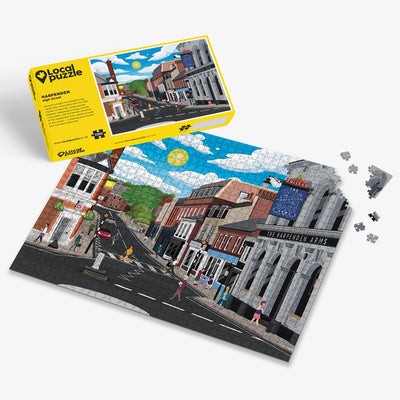 Harpenden High Street Jigsaw puzzle with a colourful scene of a town centre and yellow box packaging on a white background