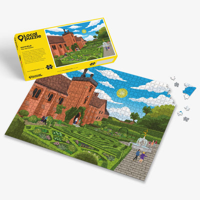 Hatfield Old Palace Jigsaw puzzle with a colourful scene of a old manor house and garden with yellow box packaging on a white background