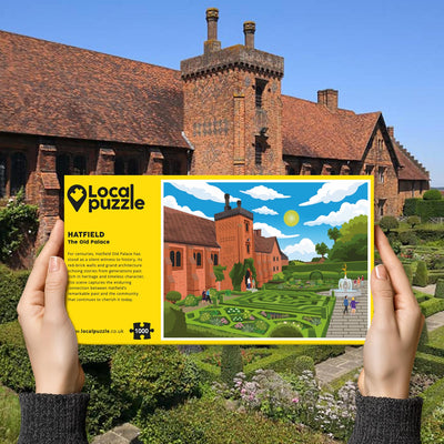 Hands holding "local Puzzle" box for Hatfield Old Palace jigsaw puzzle in front of the actual location 