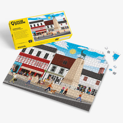 Hertford Parliament Square Jigsaw puzzle with a colourful scene of a town square and yellow box packaging on a white background