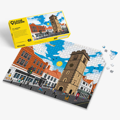 St Albans Clock Tower Jigsaw puzzle with a colourful town scene and yellow box packaging on a white background