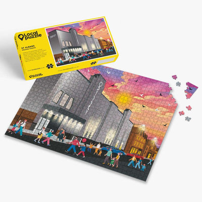 St Albans Odyssey Cinema Jigsaw puzzle with a colourful scene of buildings and yellow box packaging on a white background