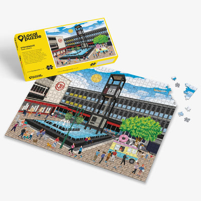 Stevenage town centre Jigsaw puzzle with a colourful scene of a town square and yellow box packaging on a white background