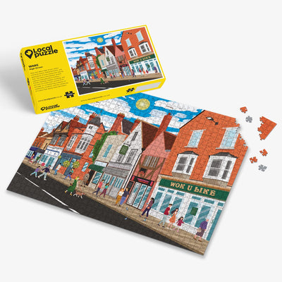 Ware High Street Jigsaw puzzle with a colourful scene of a town centre and yellow box packaging on a white background