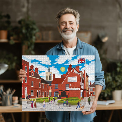 Man holding a completed Baldock Town Centre jigsaw puzzle in his office or studio