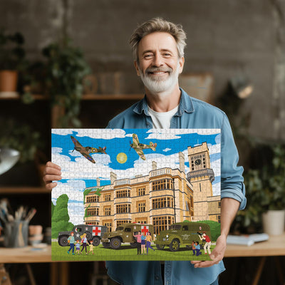 Man holding a completed Biggleswade Shuttleworth House jigsaw puzzle in his office or studio