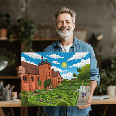 Man holding a completed Hatfield Old Palace jigsaw puzzle in his office or studio