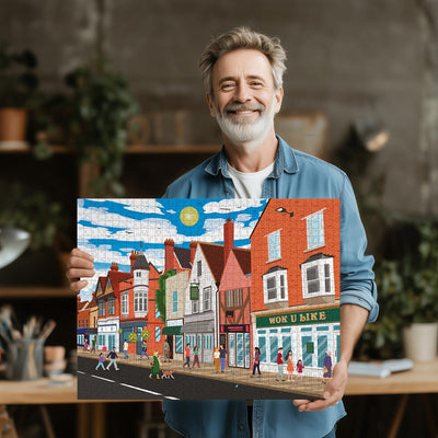 Man holding a completed Ware High Street jigsaw puzzle in his office or studio