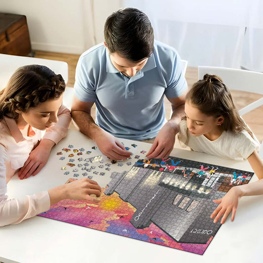 A mum, dad and daughter working on solving our St Albans Odyssey Cinema jigsaw puzzle at home