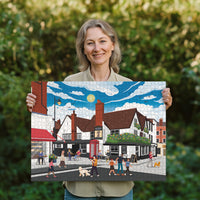 Woman holding a completed St Albans town centre jigsaw puzzle in her garden