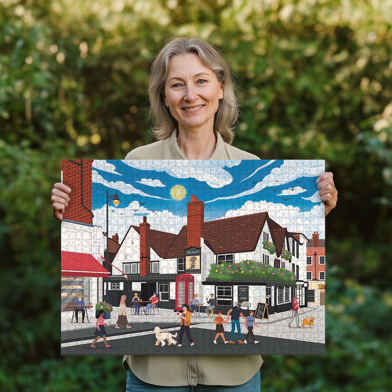 Woman holding a completed St Albans town centre jigsaw puzzle in her garden