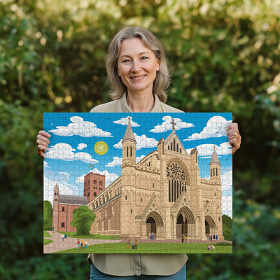 Woman holding a completed St Albans Cathedral jigsaw puzzle in her garden