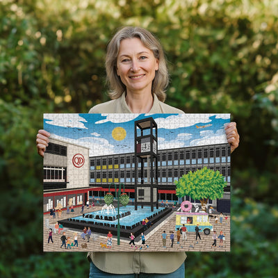 Woman holding a completed Stevenage town centre jigsaw puzzle in her garden